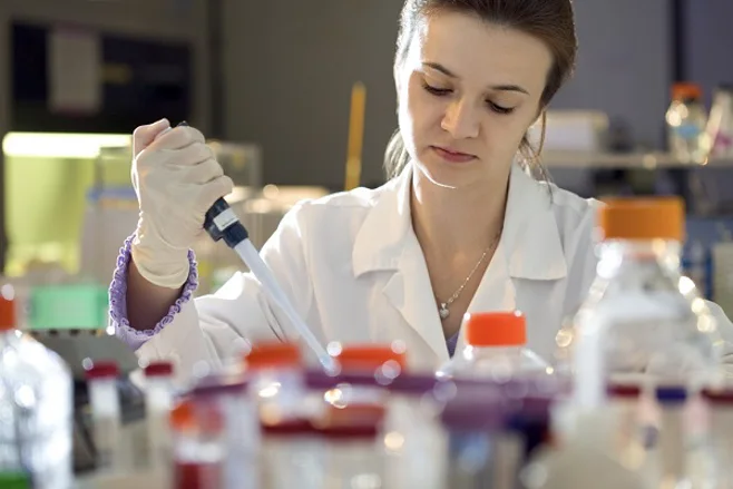 Scientist with Pipette in Medical Lab Scientist with Pipette in Medical Lab